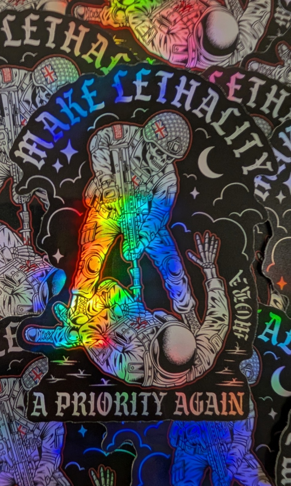 A close-up of a black graphic sticker or decal featuring a skeleton soldier in standing over another figure, with rainbow holographic text reading 'MAKE LETHALITY A PRIORITY AGAIN'.